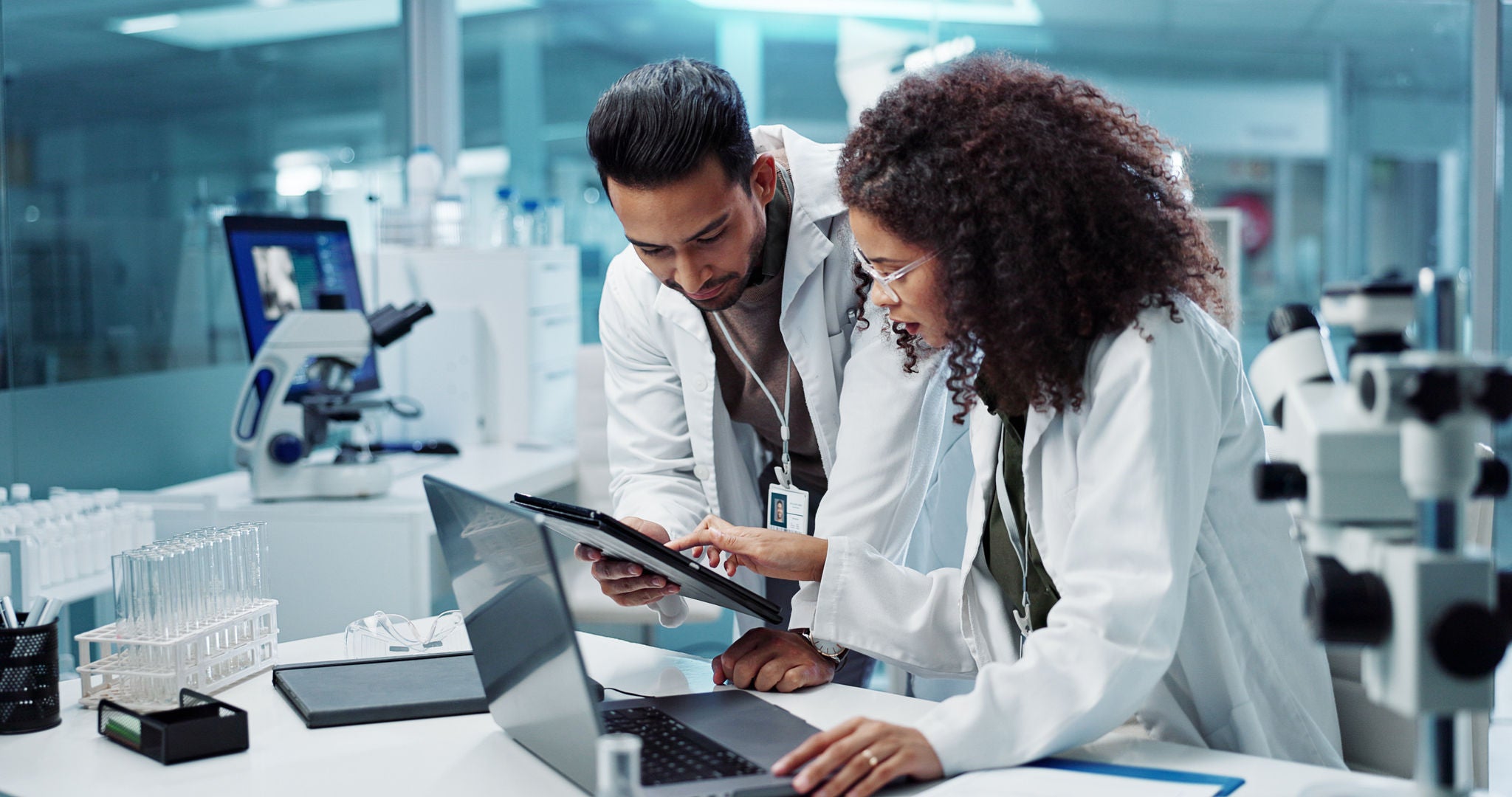 Science, teamwork and scientist with tablet in laboratory for communication, pharmaceutical review or planning. Employees, collaboration and technology for research, discussion and digital analysis.