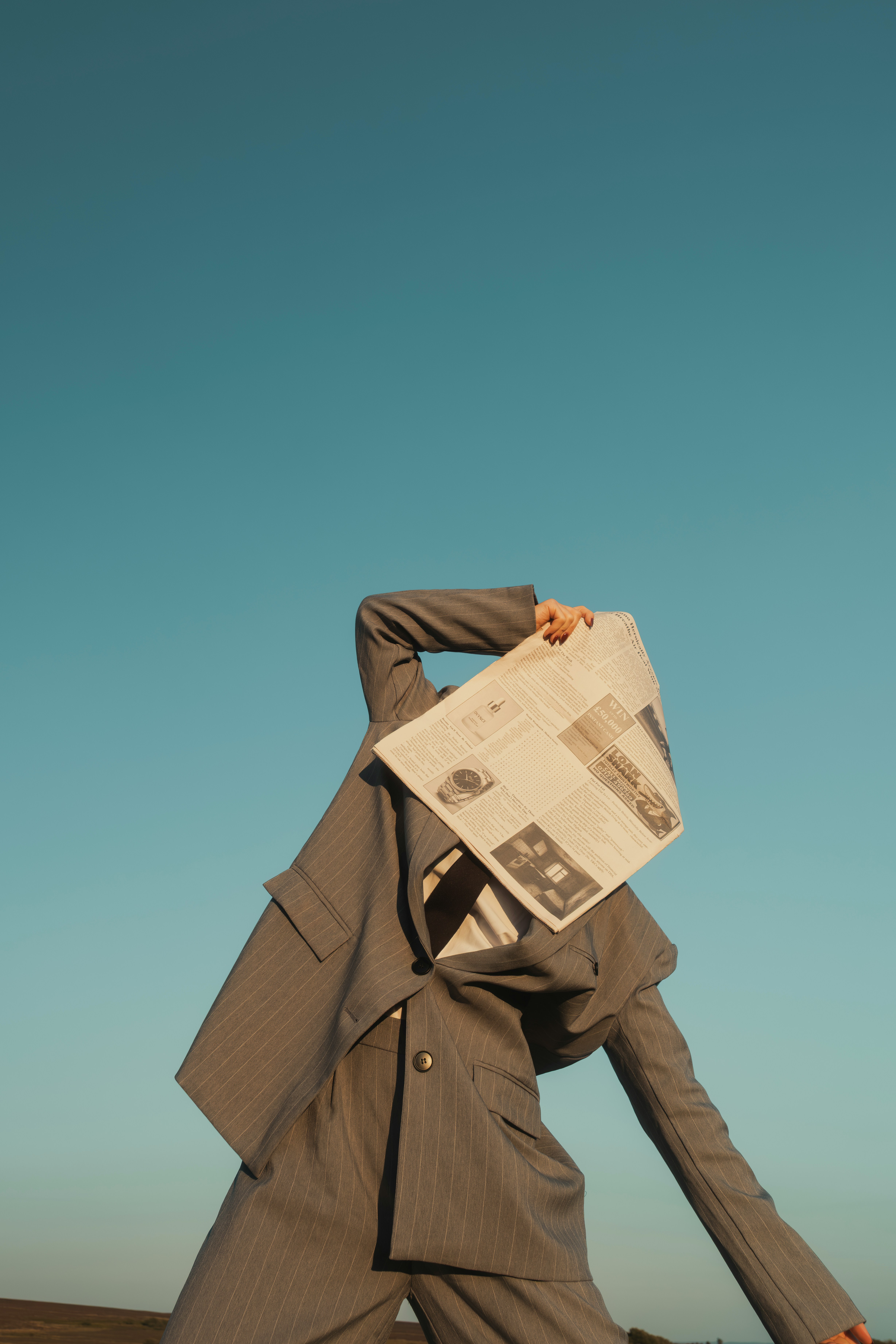 man covers face with newspaper